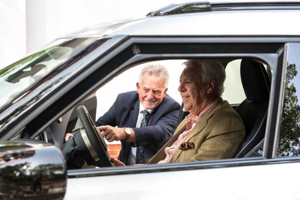 A chauffeur and resident at Battersea Place familiarising themselves with the self-drive car.