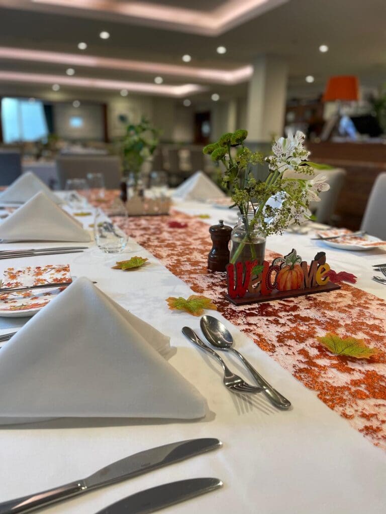 Image of tables dressed in an autumnal style ahead of food service