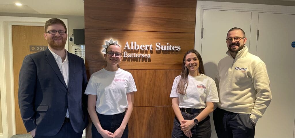 Lottie and LifeCare Residences team posing for a photo in front of The Albert Suites sign during a recent visit
